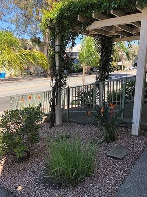 Burlingame apartment for rent - a gazebo with flowers and plants in a garden
