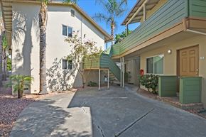Menlo Park apartment for rent - a driveway in front of a white house with a wooden door