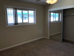 Mountain View apartment for rent - a living room with a mirrored closet and two windows