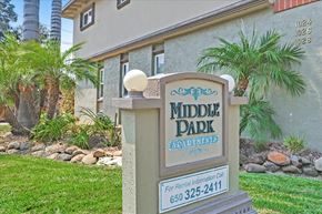 Menlo Park apartment for rent - A sign for Middle Park Apartments stands in front of a building.