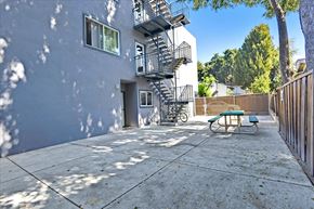 Redwood City apartment for rent - a patio with a fire escape on the side of a building