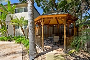 Menlo Park apartment for rent - A wooden gazebo is surrounded by trees and plants.