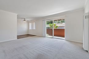 Menlo Park apartment for rent - A spacious room with a carpeted floor and sliding glass doors leading to a balcony.
