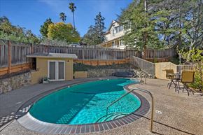 Los Gatos apartment for rent - a pool with a house and trees in the background