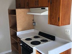 Mountain View apartment for rent - a small kitchen with a white stove and wooden cabinets