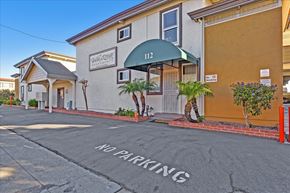 San Mateo apartment for rent - A building with a green awning and the number 112 on it.