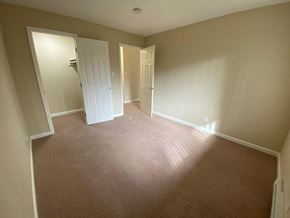 Burlingame apartment for rent - a empty room with a carpeted floor and a door to a closet