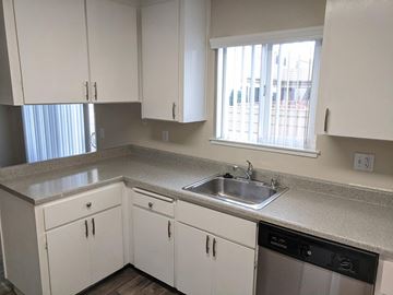 Mountain View apartment for rent - a kitchen with white cabinets and a sink