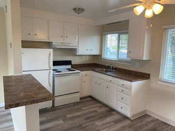 Santa Clara apartment for rent - A kitchen with white cabinets and a marble countertop.