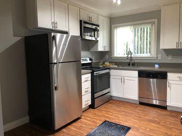 Mountain View apartment for rent - a kitchen with stainless steel appliances and white cabinets