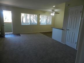 Redwood City apartment for rent - A room with a carpeted floor and a ceiling fan.