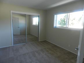 Redwood City apartment for rent - A room with a carpeted floor and a sliding glass door.