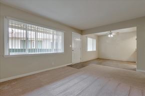 Menlo Park apartment for rent - the living room and dining room of an empty home with a large window