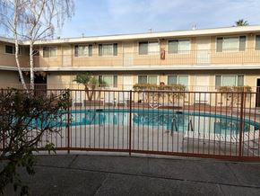Mountain View apartment for rent - a swimming pool is behind a wrought iron fence