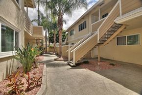 Sunnyvale apartment for rent - a building with stairs and palm trees in front of it