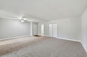 Sunnyvale apartment for rent - A spacious room with a ceiling fan and carpeted floor.