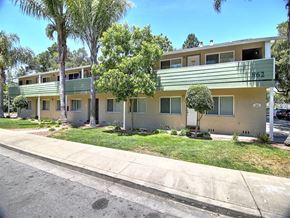 Menlo Park apartment for rent - A row of houses with green lawns and trees.