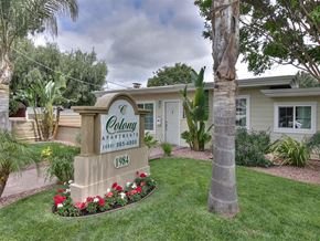Mountain View apartment for rent - a home with a sign in front of a lawn and a palm tree
