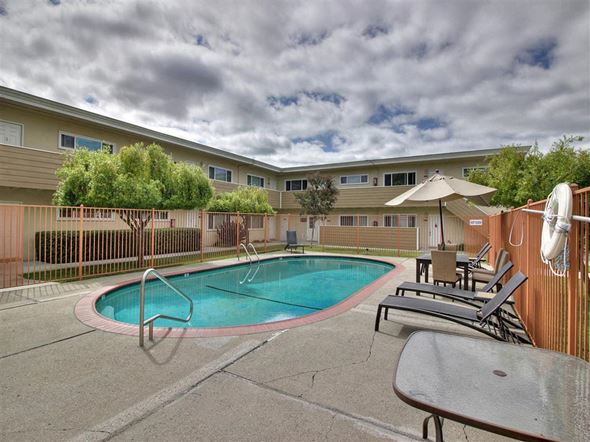 Mountain View apartment for rent - a swimming pool and patio with chairs and umbrellas