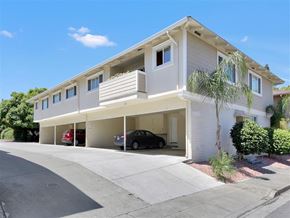 Mountain View apartment for rent - A two-story house with a garage and a car parked inside.