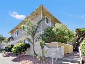 Mountain View apartment for rent - A house with a white fence and a tree in front.