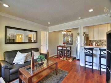 Mountain View apartment for rent - a living room and kitchen with a couch and a table