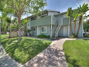 Sunnyvale apartment for rent - A building with a green lawn and a sign in front of it.