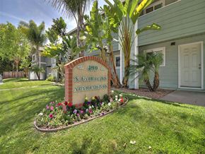 Sunnyvale apartment for rent - A sign for N. Fair Oaks Apartments is surrounded by flowers and greenery.