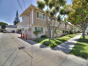 Sunnyvale apartment for rent - A residential street with houses and palm trees.