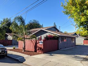 Mountain View apartment for rent - a house with a red fence and a tree in front of it