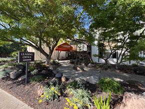 Palo Alto apartment for rent - A leasing office is surrounded by trees and plants.