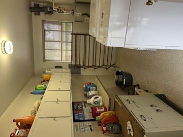 Menlo Park apartment for rent - A kitchen with white cabinets and a white counter top with many items on it.