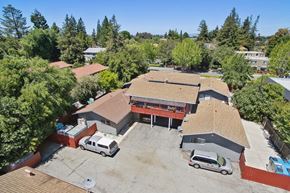 Mountain View apartment for rent - A large building with a parking lot in front of it.