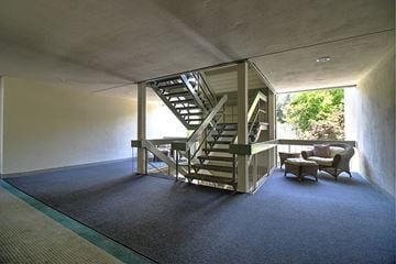 Redwood City apartment for rent - a living room with a staircase and a couch