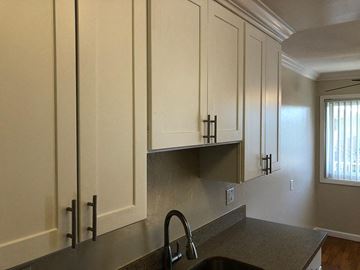 Mountain View apartment for rent - a kitchen with white cabinets and a sink