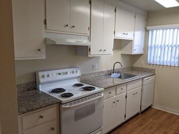 Mountain View apartment for rent - A kitchen with white cabinets and a granite countertop.