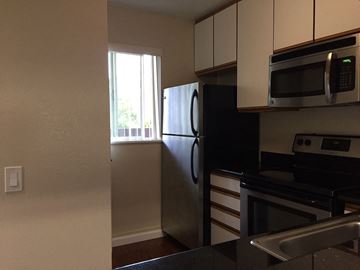 Belmont apartment for rent - A kitchen with a black refrigerator and stainless steel appliances.
