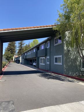 Sunnyvale apartment for rent - A row of houses under a bridge on a sunny day.