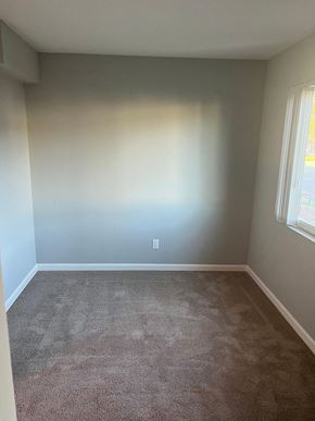 Mountain View apartment for rent - an empty room with a carpet and two windows