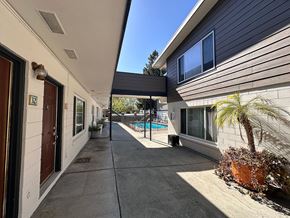 Mountain View apartment for rent - A sunny day at a residential area with a pool and a house numbered 52.