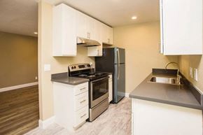 San Mateo apartment for rent - a kitchen with stainless steel appliances and white cabinets