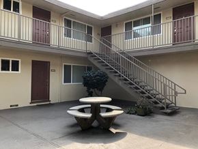 Mountain View apartment for rent - an outside view of an apartment building with a table and a staircase