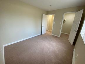 Burlingame apartment for rent - a bedroom with a carpeted floor and a door to a closet