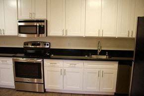 San Mateo apartment for rent - a kitchen with a stove microwave and white cabinets