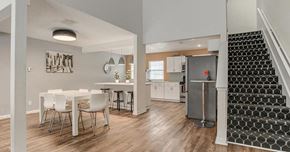 Kansas City apartment for rent - A dining area with a white table and chairs is shown.