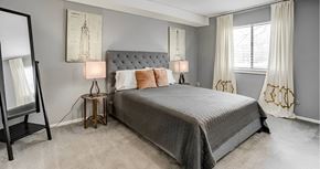 Kansas City apartment for rent - A bedroom with a large bed and two lamps.