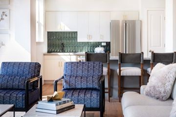 Roseville apartment for rent - A living room with a blue chair and a grey couch.
