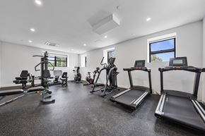 Passaic apartment for rent - A spacious gym with treadmills, elliptical machines, and other exercise equipment.