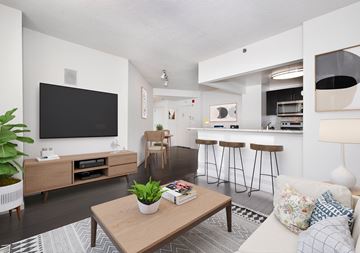 West New York apartment for rent - A living room with a wooden coffee table and a flat screen TV mounted on the wall.