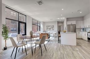 Passaic apartment for rent - A modern kitchen with a dining table and chairs.